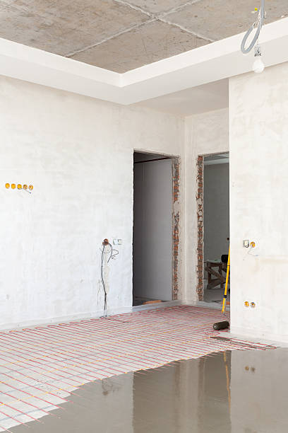 istock Electric floor heating system installation in new house. 584464304
