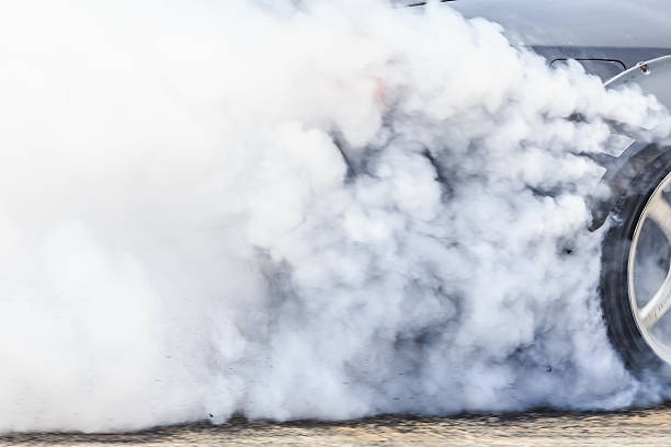 Drag racing car burns rubber off its tires