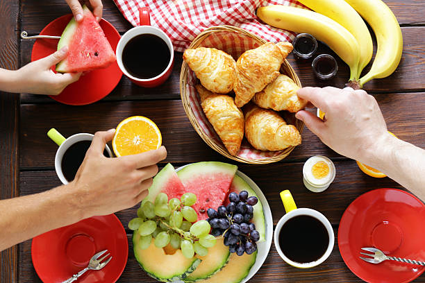 istock coffee, croissant, fruit breakfast on a wooden table, top view 584468130