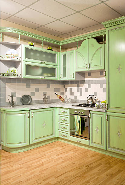 istock Luxurious new green kitchen with modern appliances 584468334