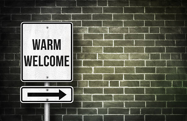 istock Warm welcome road sign concept 584470302