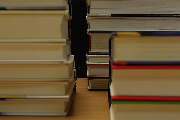 istock Many books stacked up on the table 584470792