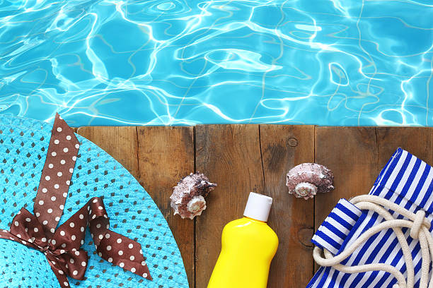 istock swimming pool and wooden deck with beach accessories 584471056