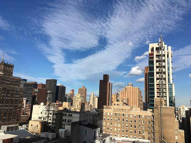 istock Wispy Clouds sweep across Manhattan Skyline 584471692