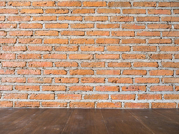 istock Red brick wall and wood floor 584472252