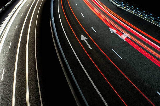 trails lines line red white asphalt road arrow direction night