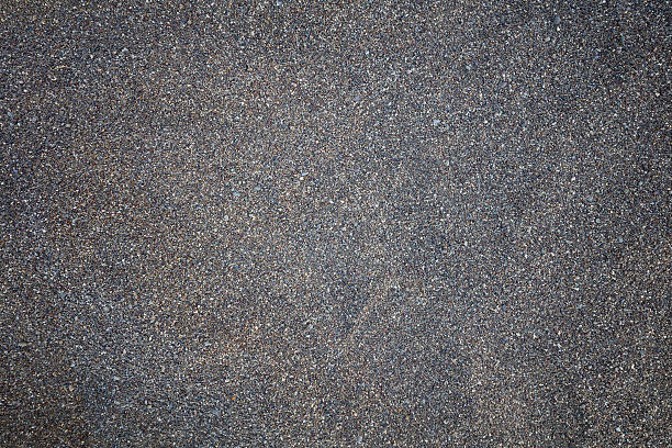 istock Close up of dark sand texture 584472590