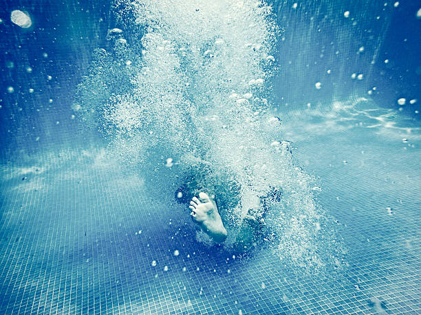 istock Girl diving underwater in swimming pool 584473228