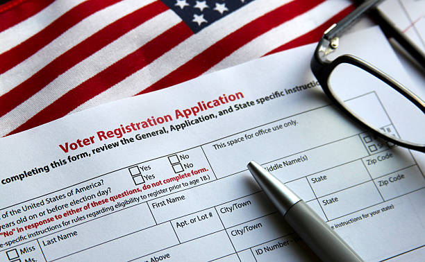 Voter Registration Voter registration form with flag of United States of America voter registration photos stock pictures, royalty-free photos & images