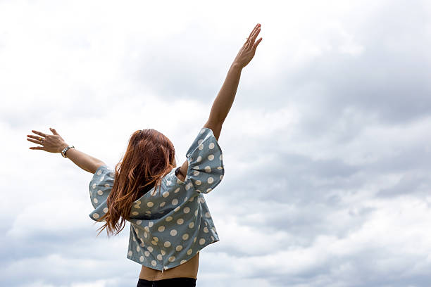 istock Happy girl smiling in Nice Sky 584476330