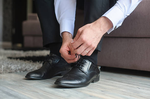 istock Man ties his shoes. 584476938