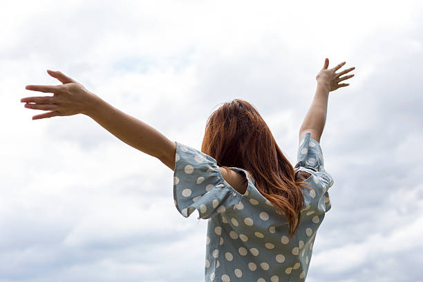 istock Happy girl smiling in Nice Sky 584476978