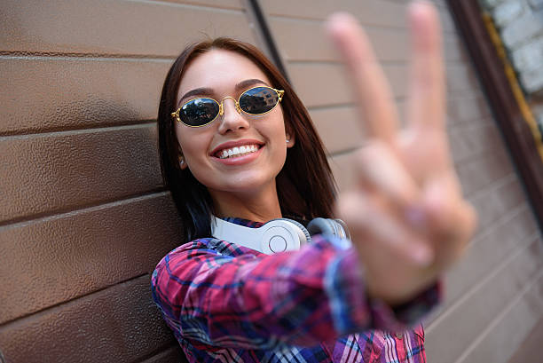 istock Cheerful young woman gesturing positively 584477668