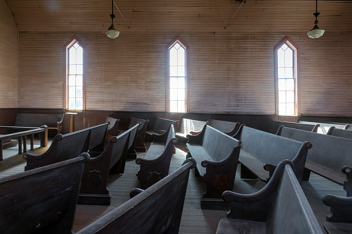 Interior of the Methodist Church in Bodie, California, a ghost town maintained as the Bodie State Historic Park.  It is also recognized as the Bodie Historic District by the US Department of the Interior.  It is maintained in a state of “arrested decay” by the nonprofit Bodie Foundation. The town began after a gold strike in 1859, reached its peak population of 5,000-7,000 in 1879, but declined to 120 persons by 1912.  In 1962, the remaining landowner sold the town to the state of California.  Bodie is located in Mono County 12 miles southeast of the town of Bridgeport at an elevation of 8379 feet (2554 m).