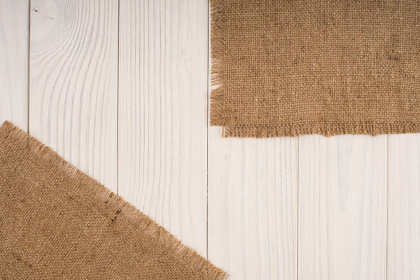 istock Burlap texture on wooden table background 584479022