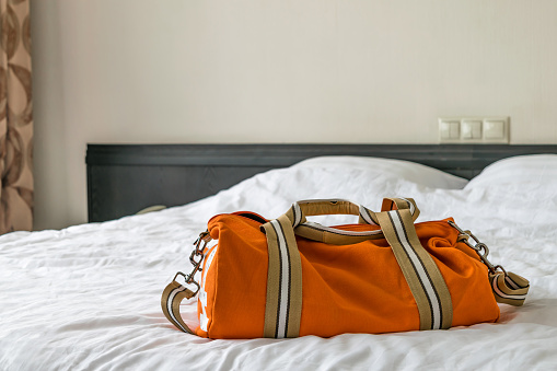 Orange bag on the bed
