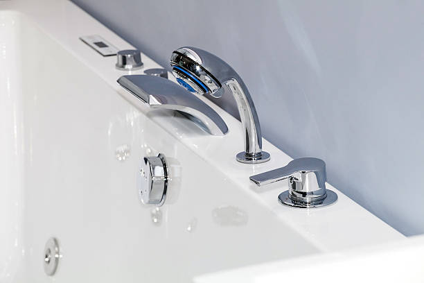 istock Modern chrome faucet in bathroom 584480886