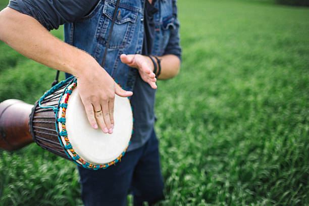 istock Male playing ethnic drum outdoors 584481698