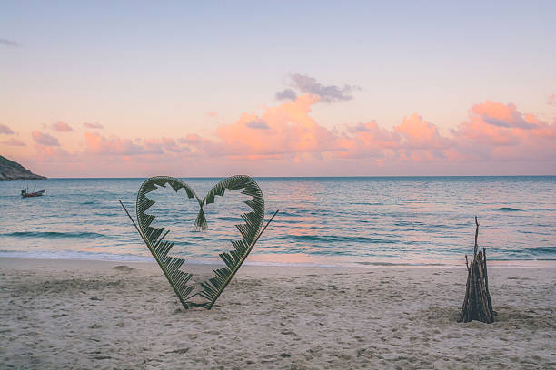 istock Palm branches tied into the shape of a heart on 584481720