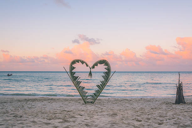 istock Palm branches tied into the shape of a heart on 584481764