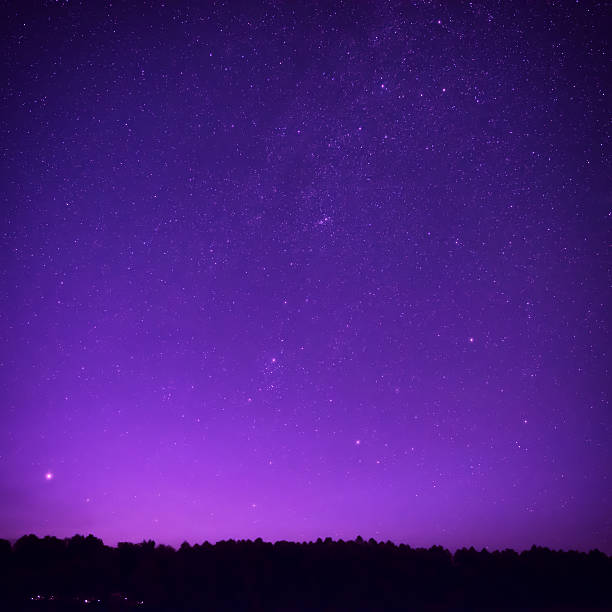 Beautiful purple night sky with many stars stock photo