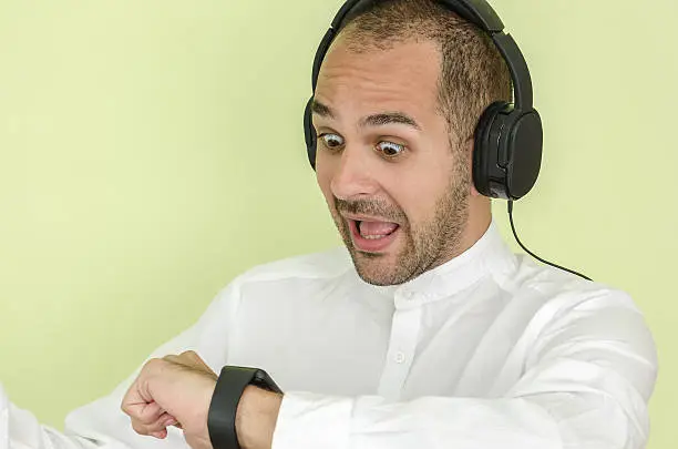 Photo of man in shirt uses a smart watch