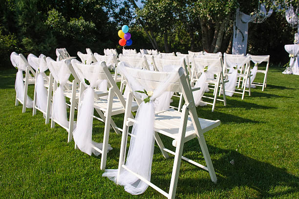 istock White decorated chairs on a green lawn 584484026