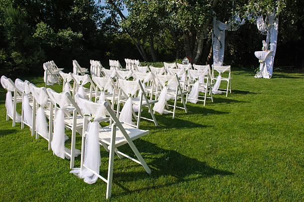 istock White decorated chairs on a green lawn 584484136