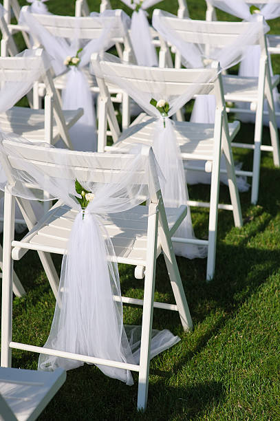 istock White decorated chairs on a green lawn 584484226