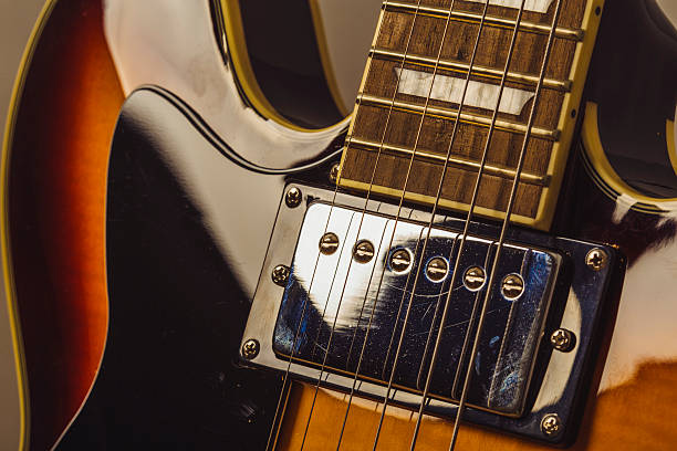istock Chrome electric pick up on a dark sunburst electric guitar 584485390