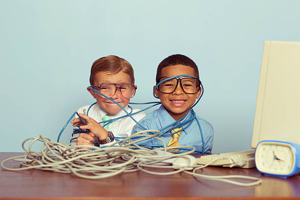 istock Young Boys and IT Professionals Smile at Computer Desk 584485546