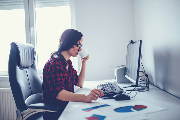 istock Girl drinks coffee at the office 584485968