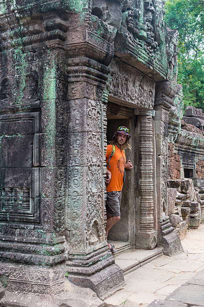 istock Young traveler wearing a hat with backpack and tripod - 584486270