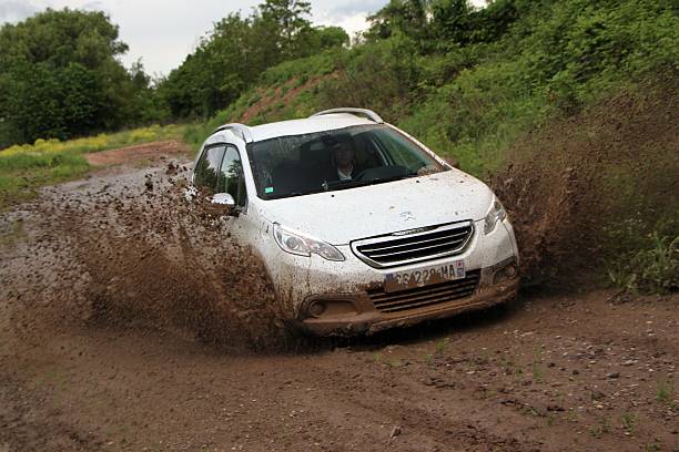 Peugeot 2008 on the muddy road stock photo