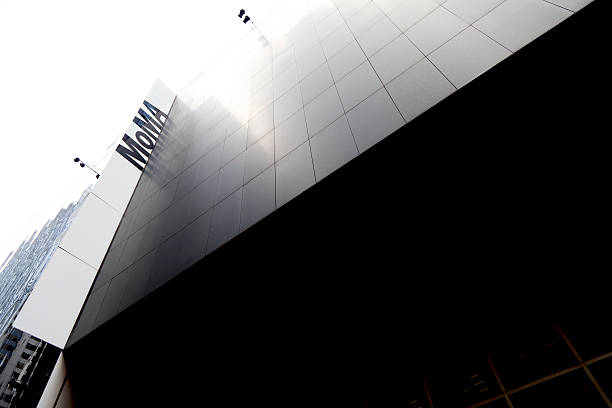 New York, USA - May 6, 2013: The Museum of Modern Art: MoMA sign and its reflection on the exerior part of the building. MoMA is the acronim of Museum of Modern Art, one of the most famous art gallery in New York.