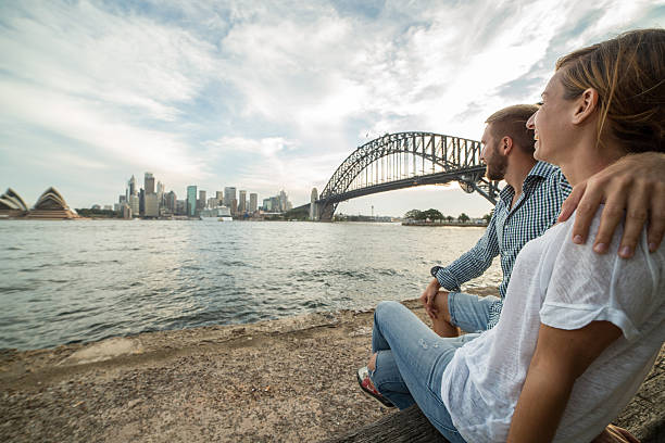 istock Young couple looking out Sydney skyline at sunset 584490030