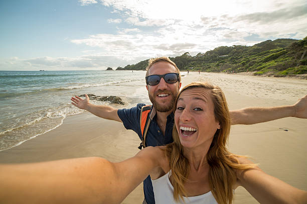 istock Two young adults take selfie portrait on beach 584490352
