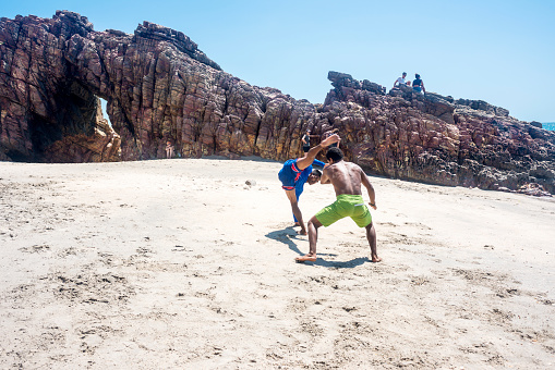 Jericoacoara, Ceara state, Brazil - July 19, 2016: Brazilian capoeiristas performing at the famous Pedra Furada Beach
