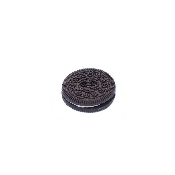 istock Chocolate cookies with creme filing isolated on white 584492838