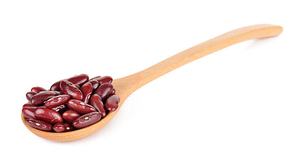 istock red bean in wooden spoon isolated on white 584494068