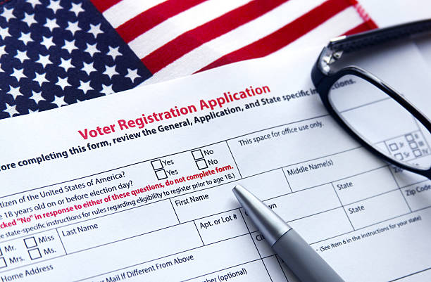 Voter Registration Application Voter registration application with flag of United States of America voter registration photos stock pictures, royalty-free photos & images