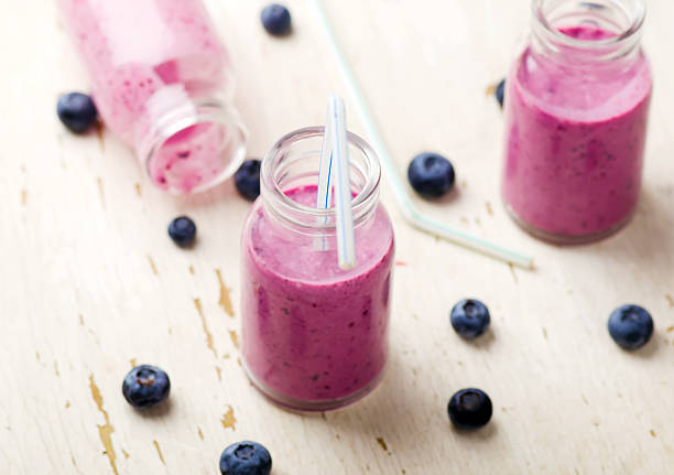 istock bilberry smoothie in glass small bottles 584495846