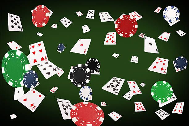 istock Playing cards flying at the poker table 584495924