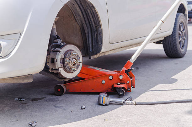 istock Car jack to lifting the car for replace wheel 584497272