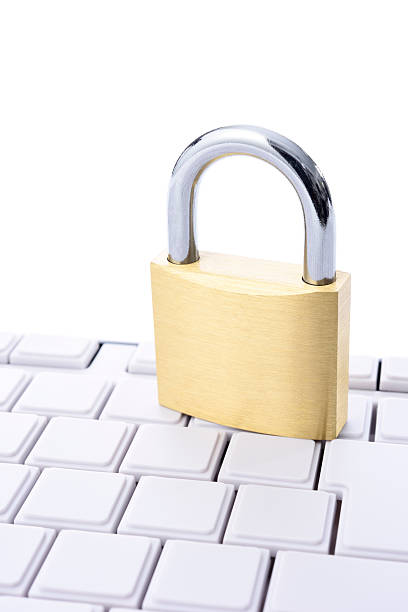 istock Close-up of locked padlock with blank keyboard on white background 584497634