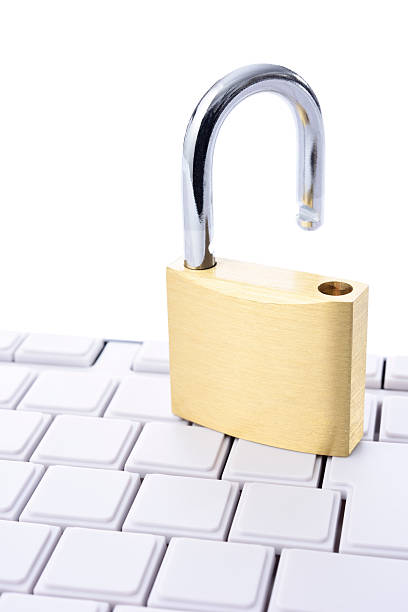 istock Close-up of unlocked padlock with blank keyboard on white background 584497848