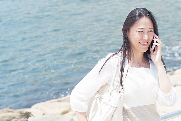 istock Japanese woman talk on the mobile phone 584498664
