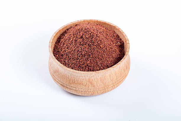 istock Sumac in a wooden bowl isolated on white background 584499340