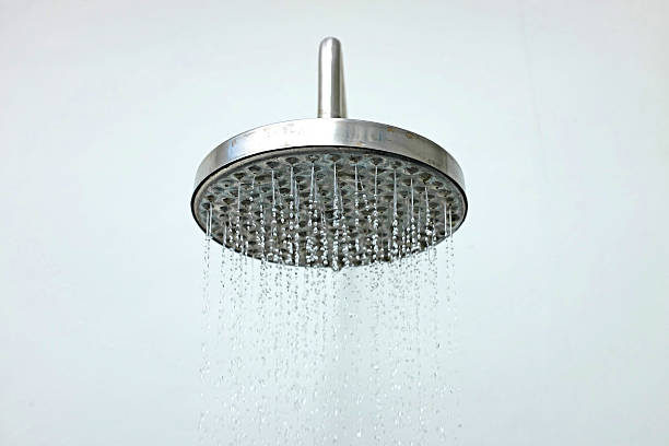 istock close up on head shower while running water 584499640