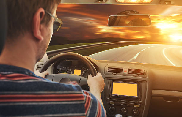 istock Man driving the car in the evening 584500338